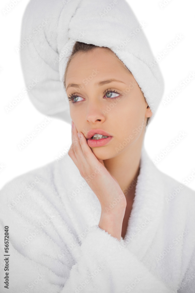 Serious brunette model in bathrobe looking away Serious brunette model in bathrobe looking away