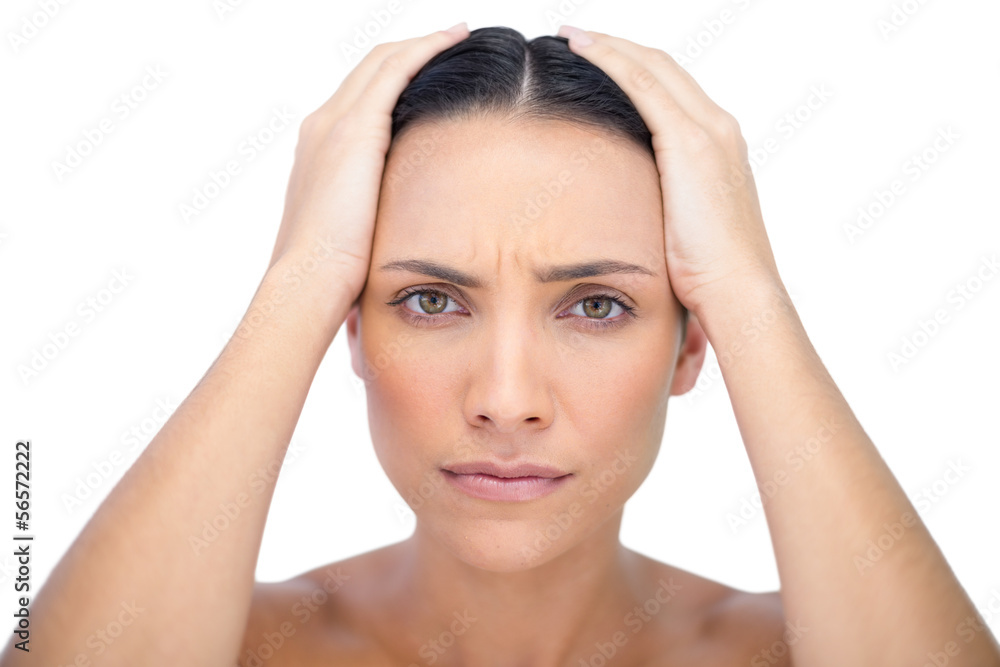 Young woman with headache touching her forehead Young woman with headache touching her forehead
