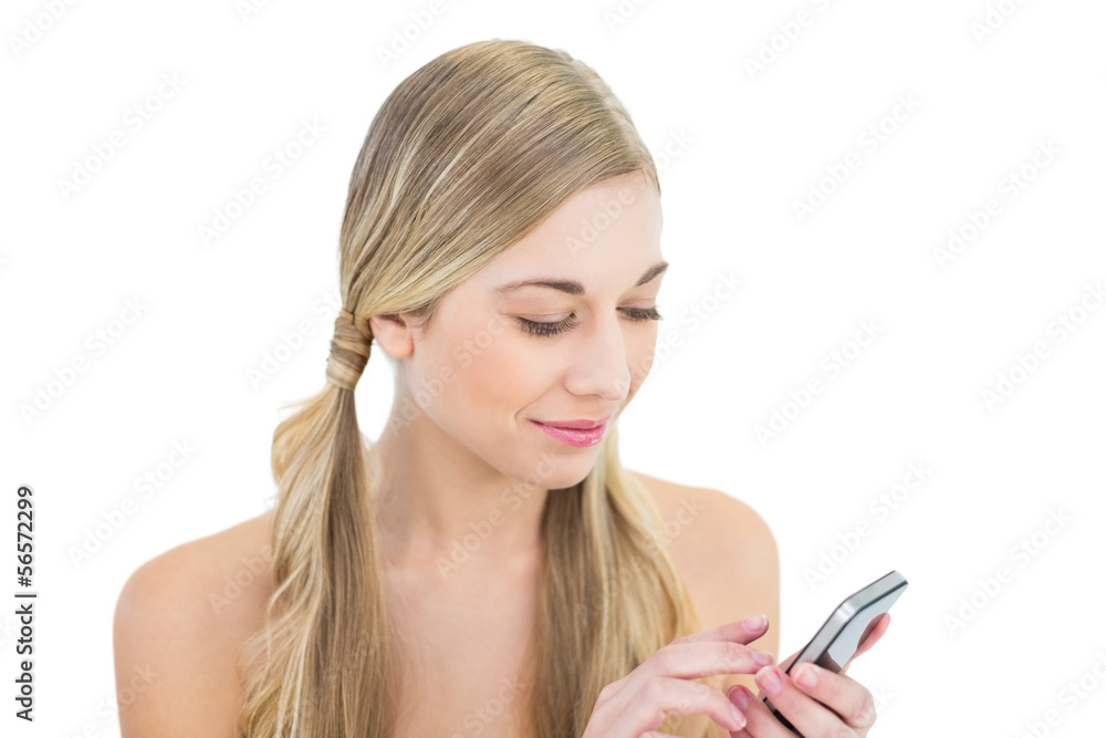 Dreamy young blonde woman using a mobile phone Dreamy young blonde woman using a mobile phone