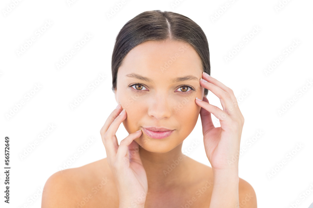 Brunette holding hands on her face looking at camera Brunette holding hands on her face looking at camera