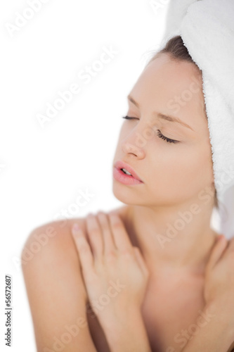 Pensive brunette drying her hair closing her eyes