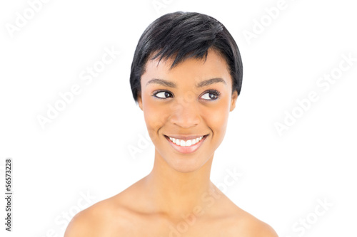 Cheerful black haired woman posing looking away