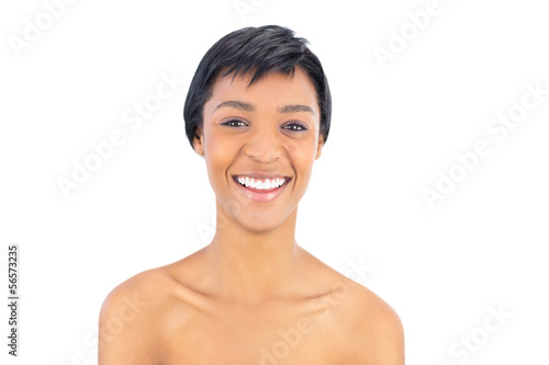 Laughing black haired woman looking at camera