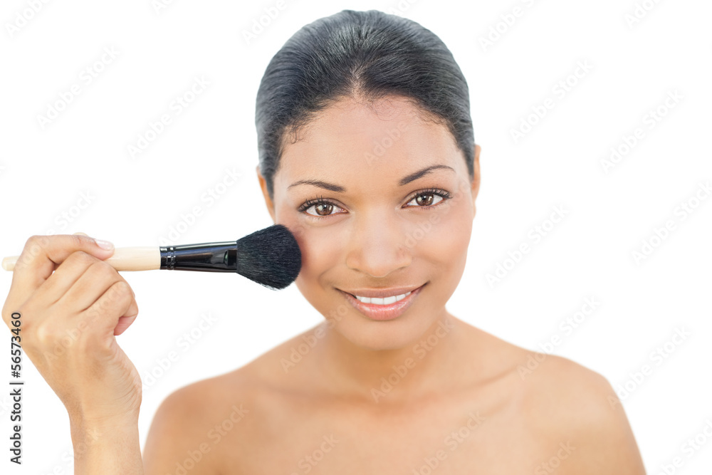 Pretty black haired model applying blusher Pretty black haired model applying blusher