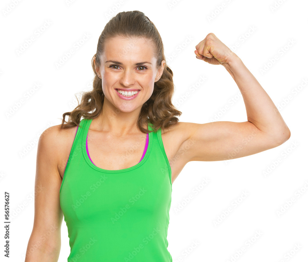 Smiling fitness young woman showing biceps Smiling fitness young woman showing biceps