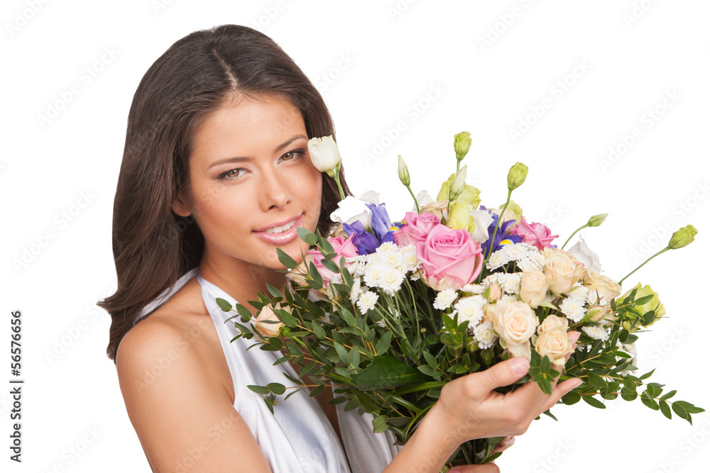 Girl with flowers. Cheerful young woman in white holding bunch o Girl with flowers. Cheerful young woman in white holding bunch o
