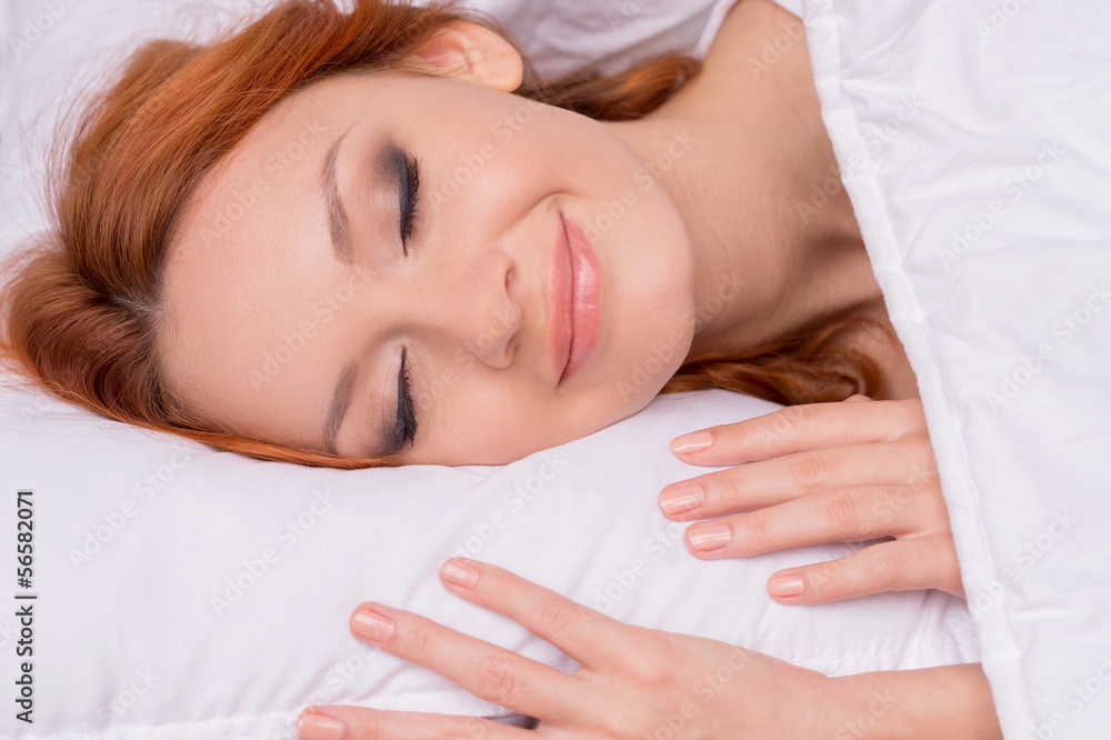 Sleeping beauty. Beautiful red hair woman sleeping and smiling