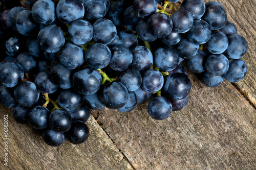 blue grapes on wooden surface
