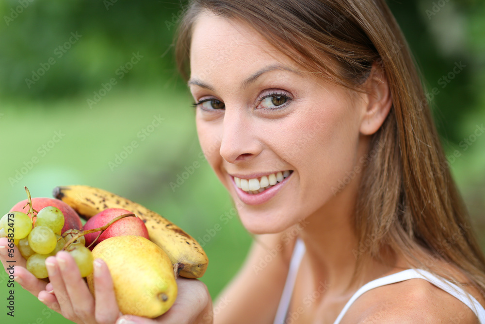 Beautiful girl eating organic fruits Beautiful girl eating organic fruits