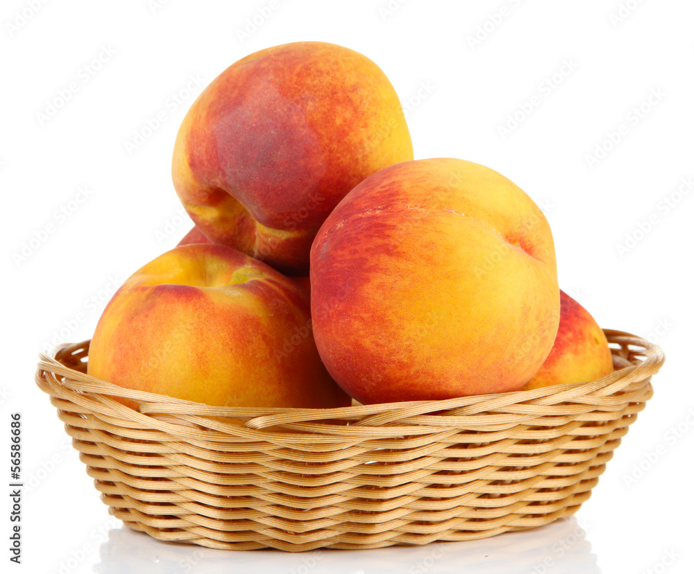Ripe sweet peaches in wicker basket, isolated on white Ripe sweet peaches in wicker basket, isolated on white