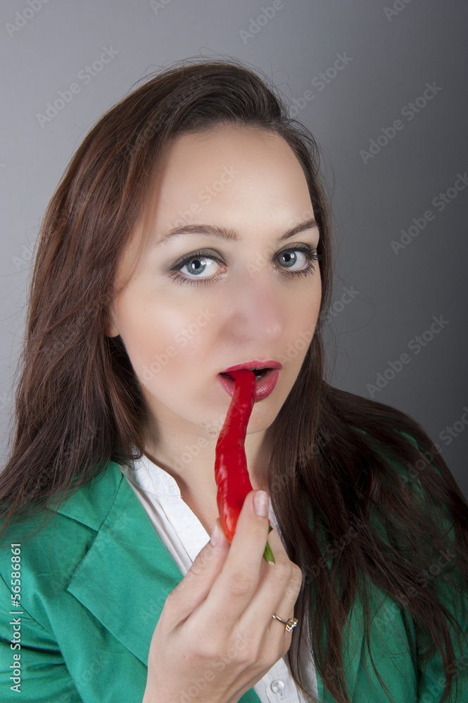 businesswoman holding red chilli pepper businesswoman holding red chilli pepper