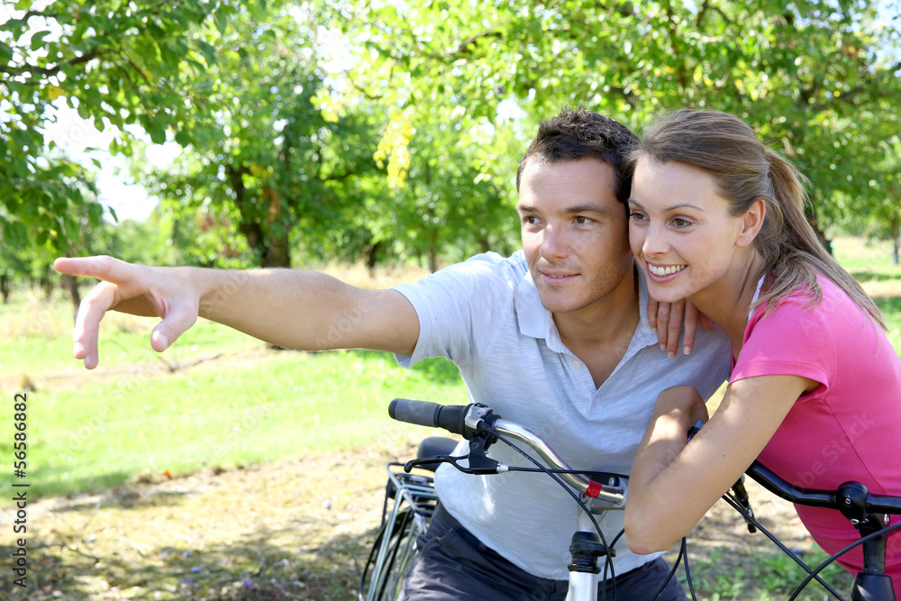 Portrait of cheerful couple on a bike ride