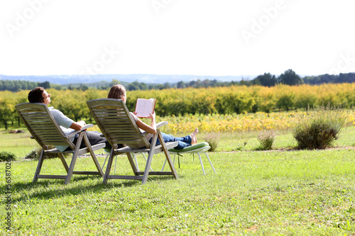 Couple relaxing in front of beautiful landscape