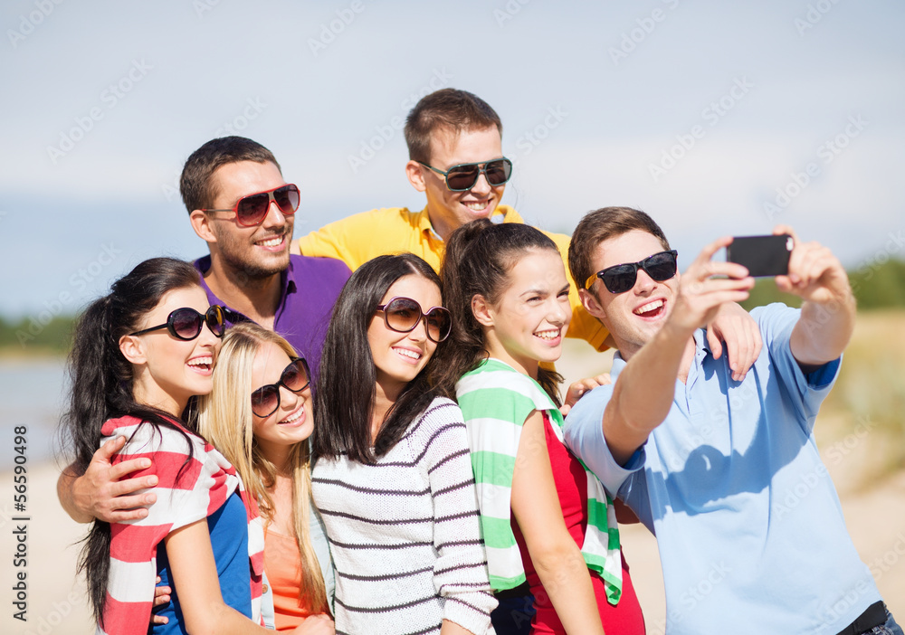 group of friends taking picture with smartphone group of friends taking picture with smartphone