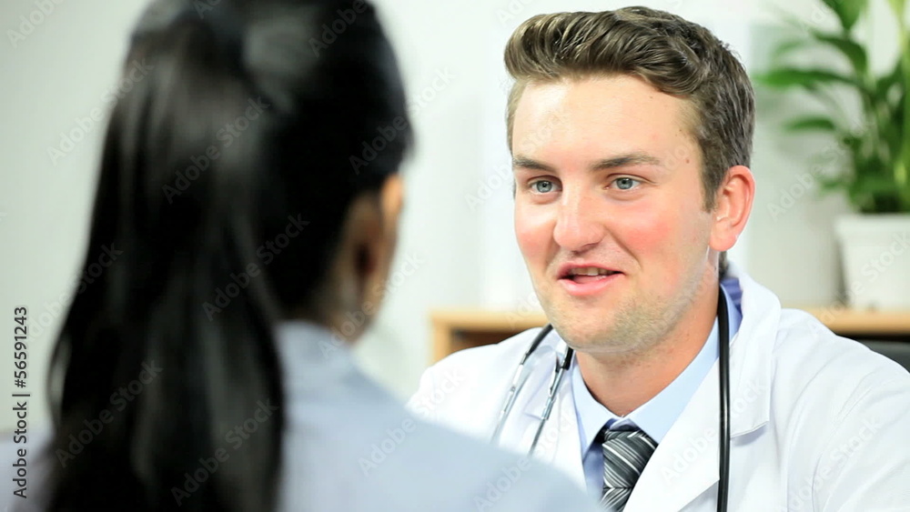 Caucasian Doctor Meeting With Ethnic Office Manager Caucasian Doctor Meeting With Ethnic Office Manager