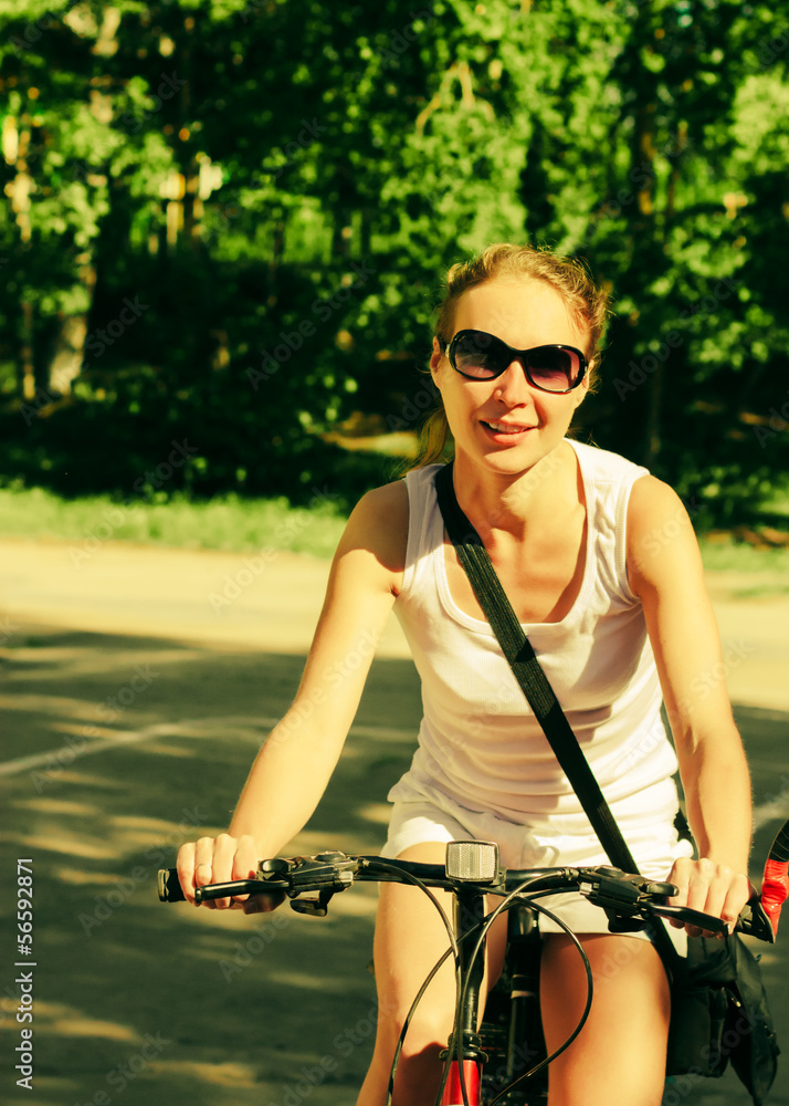 Obraz premium Woman riding bicycle outside.