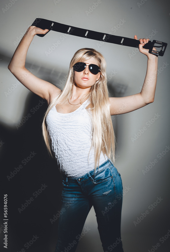 Sexy girl in sunglasses holding leather belt Stock Photo Adobe Stock