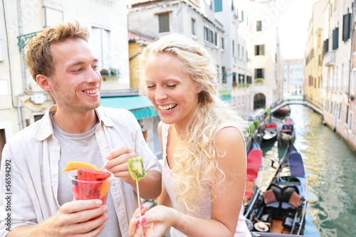 Couple eating fruit snack in Venice