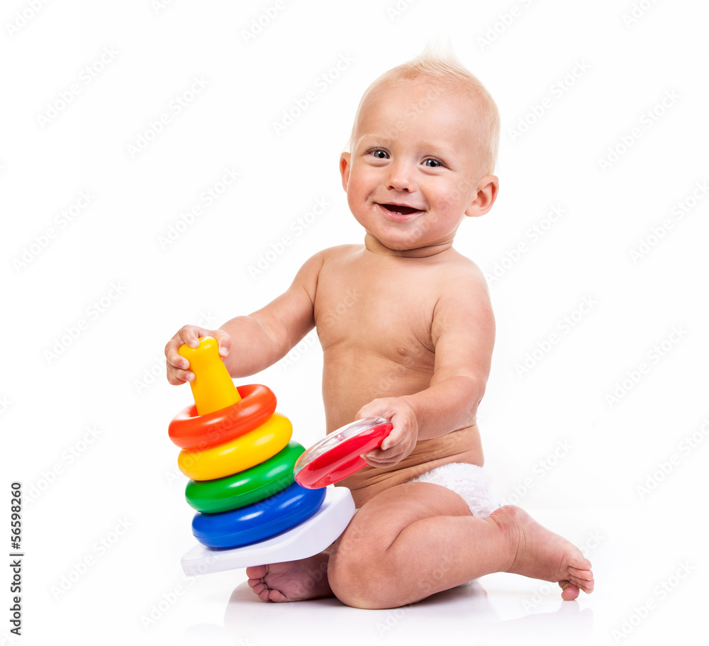 Cute little boy playing with pyramid toy over white Cute little boy playing with pyramid toy over white