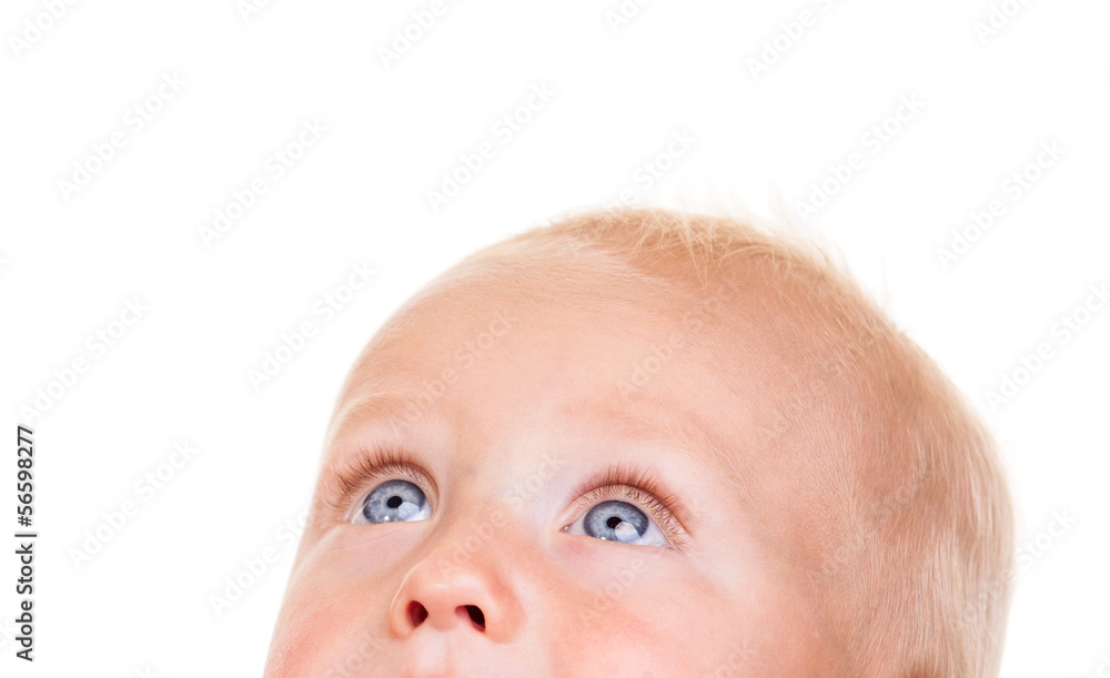 Closeup of nine-month old baby looking up over white Closeup of nine-month old baby looking up over white