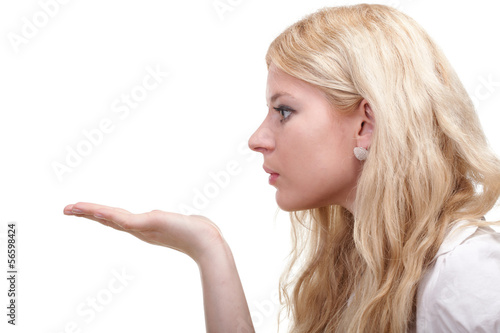 beautiful young woman blowing a kiss / having copyspace on hand