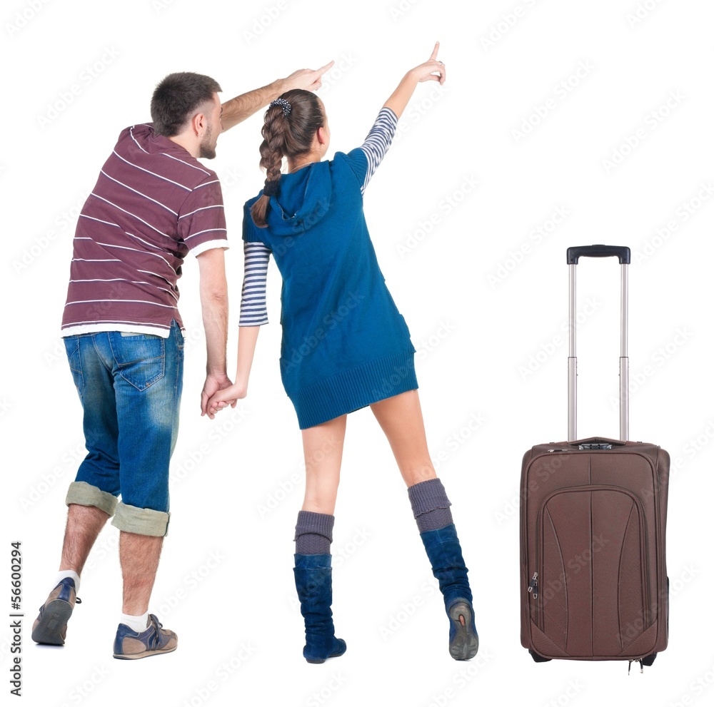 Young traveling couple with suitcas looks where that. Young traveling couple with suitcas looks where that.