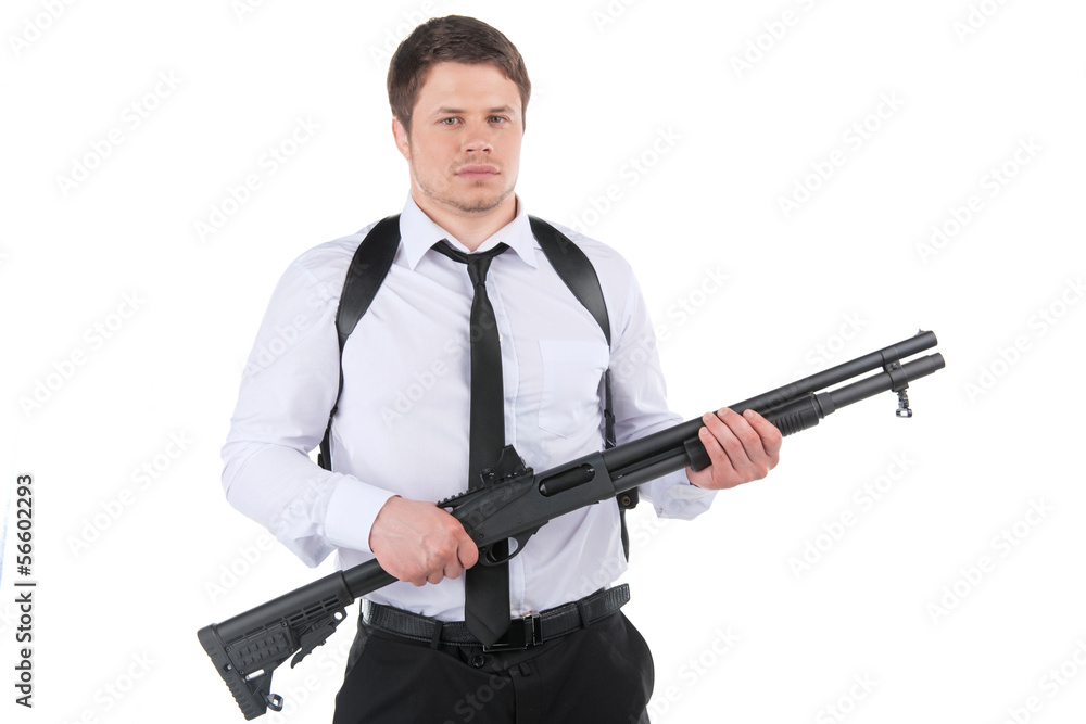 Bodyguard. Serious young man in shirt and tie holding gun and lo Bodyguard. Serious young man in shirt and tie holding gun and lo