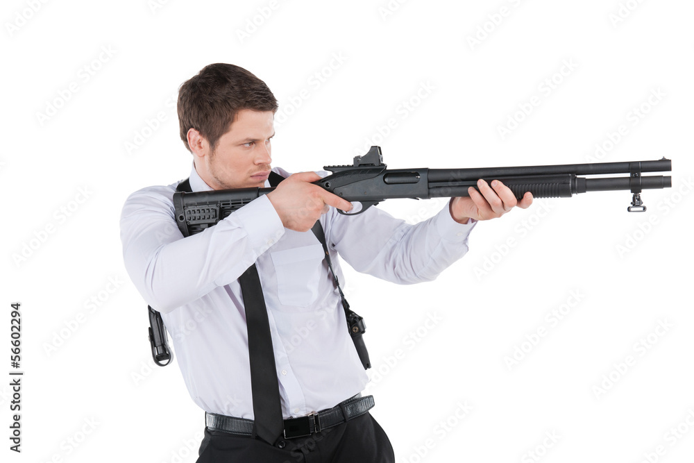 Bodyguard. Side view of confident young man in shirt and tie aim Bodyguard. Side view of confident young man in shirt and tie aim