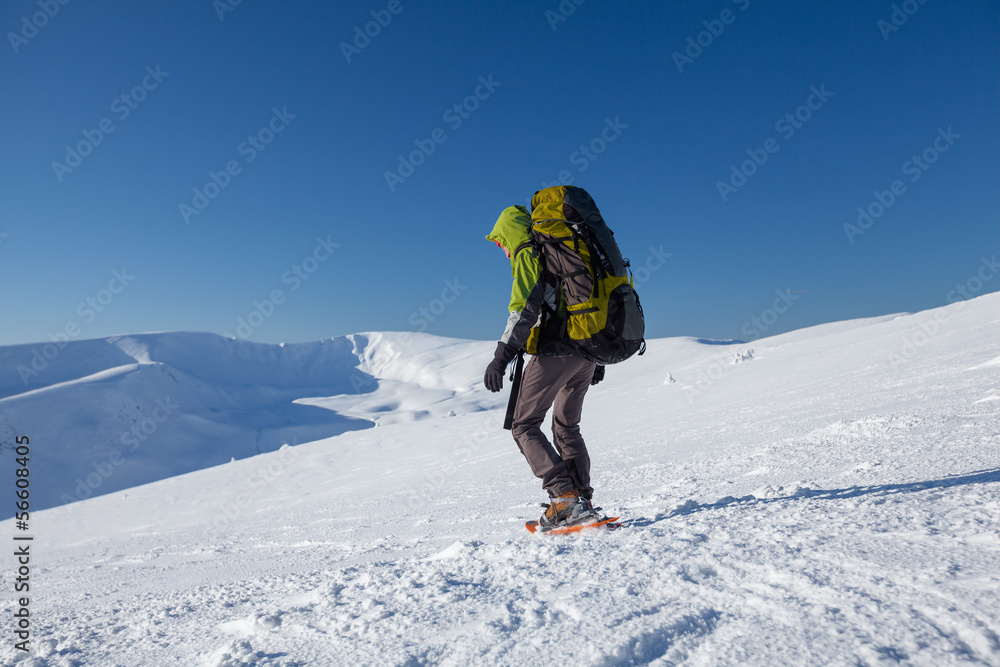 Woman snowshoeing in winter Carpathian mountains