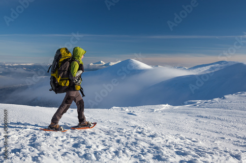 Obraz na plátně Woman snowshoeing in winter Carpathian mountains