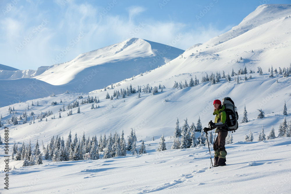 Hiker walking in winter Carpathian mountains Hiker walking in winter Carpathian mountains