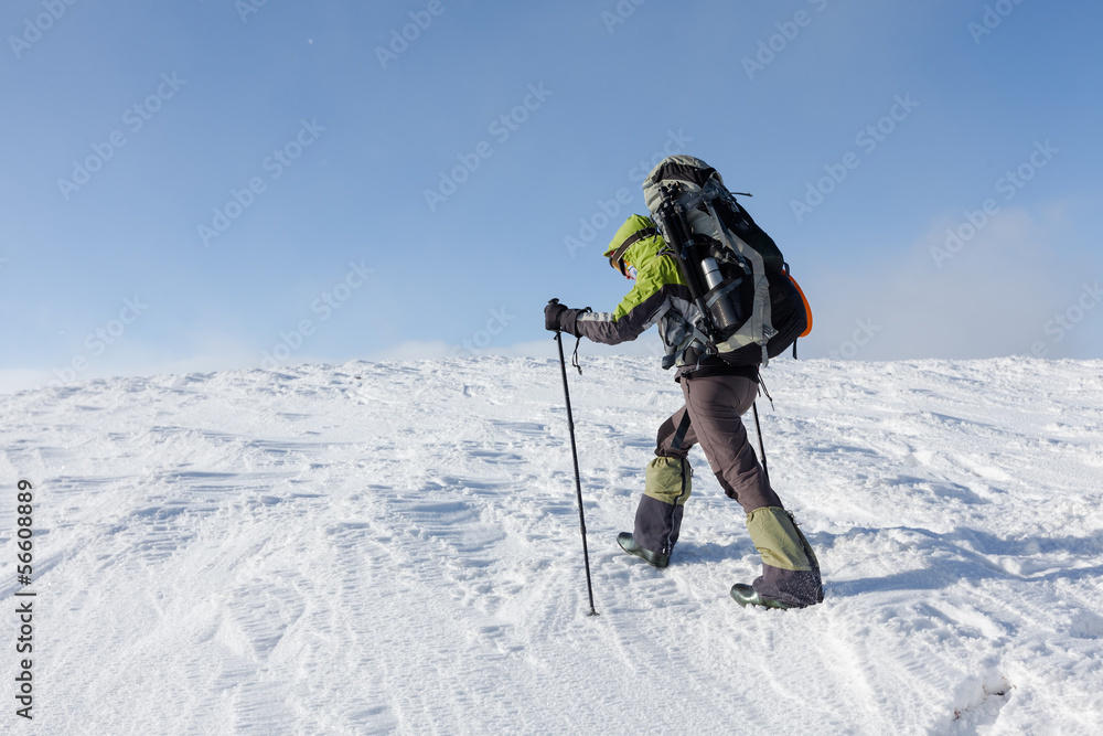 Hiker walking in winter Carpathian mountains