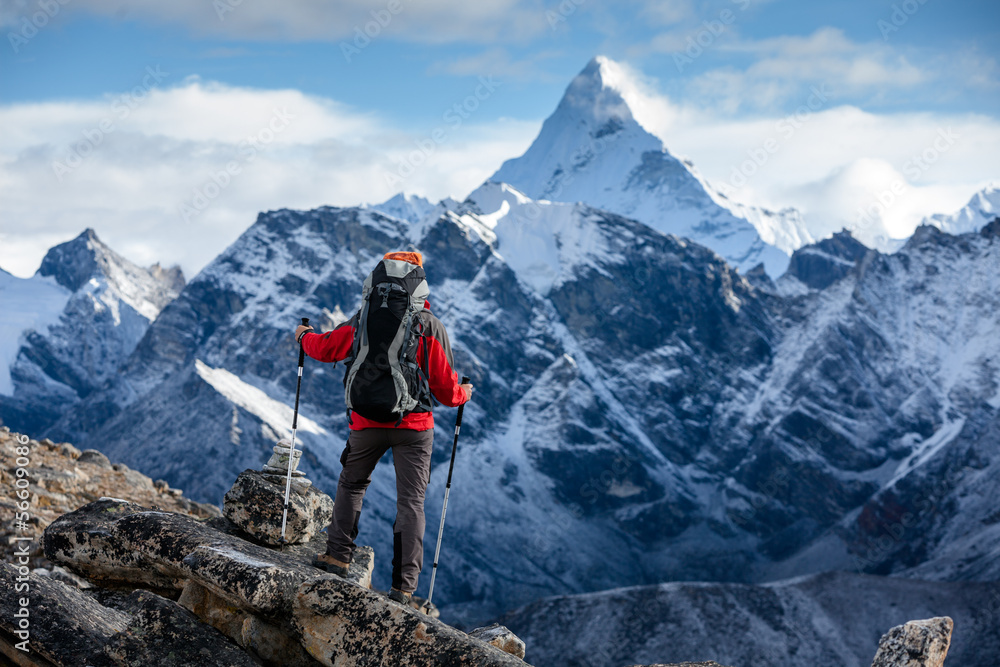 Hiker posing at camera on the trek in Himalayas, Nepal - obrazy, fototapety, plakaty 