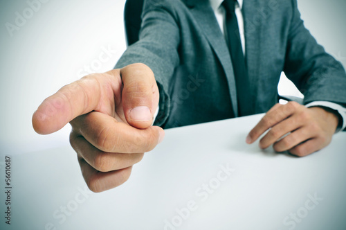 man in suit pointing with the finger the way out photo