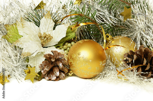 Christmas balls with tinsel, cones and artificial poinsettia