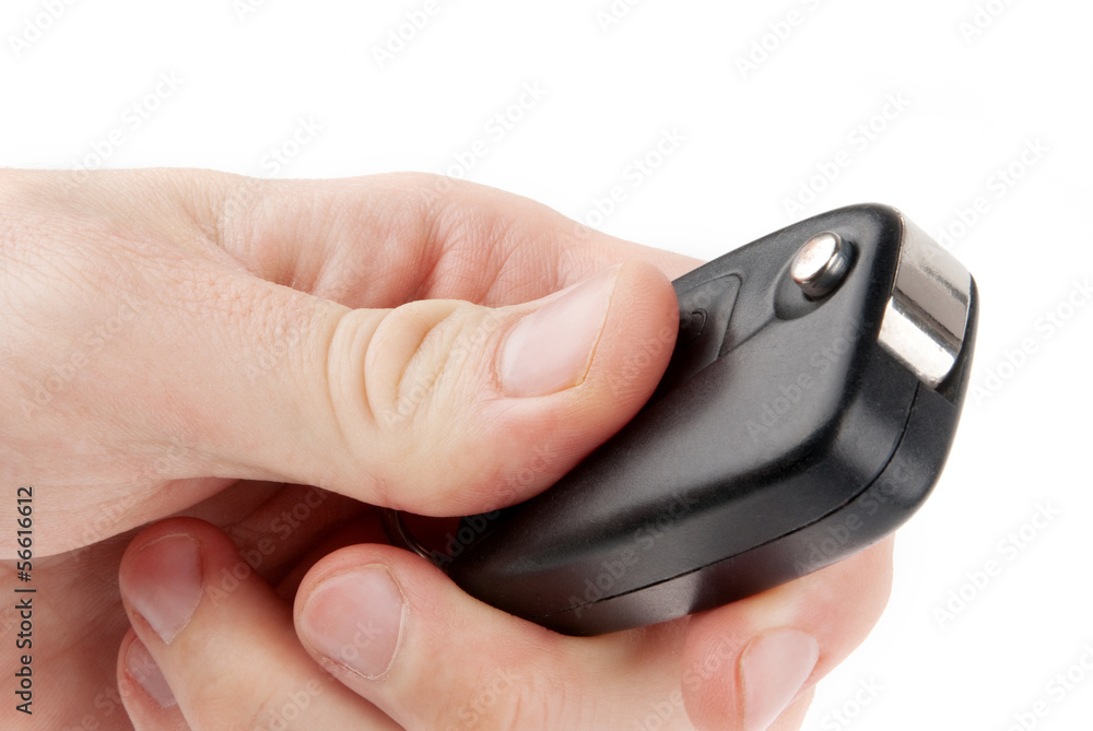Hand holding car keys isolated on white background Hand holding car keys isolated on white background