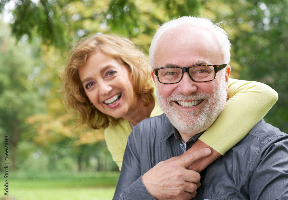 Fototapeta premium Happy older woman embracing smiling older man