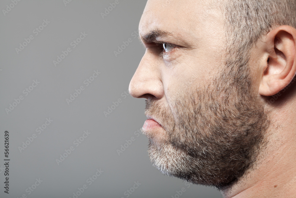 side portrait of gloomy man isolated on gray background with cop side portrait of gloomy man isolated on gray background with cop