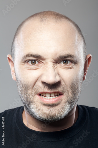 portrait of angry man isolated on gray background