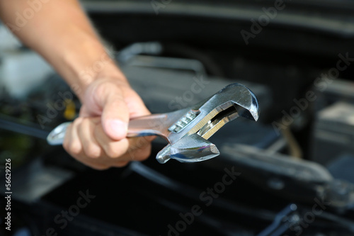 Hand with wrench. Auto mechanic in car repair © Africa Studio