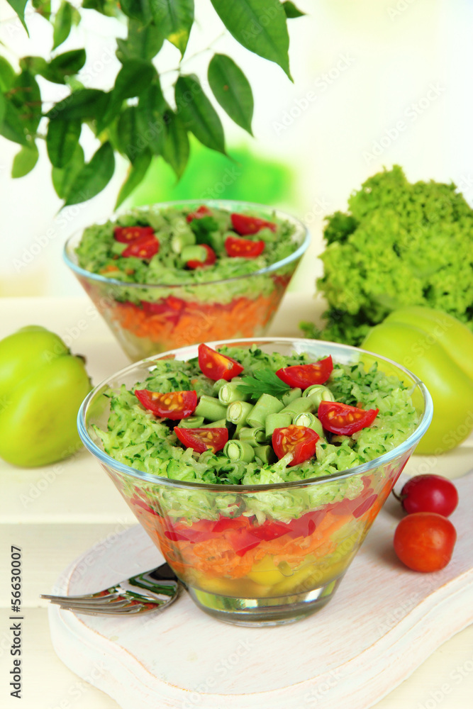 Tasty salad with fresh vegetables on wooden table Tasty salad with fresh vegetables on wooden table