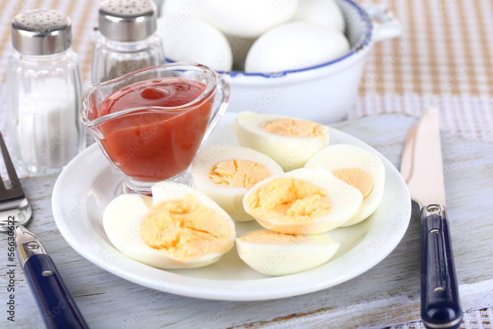 Boiled eggs on plate on wooden board on tablecloth Boiled eggs on plate on wooden board on tablecloth