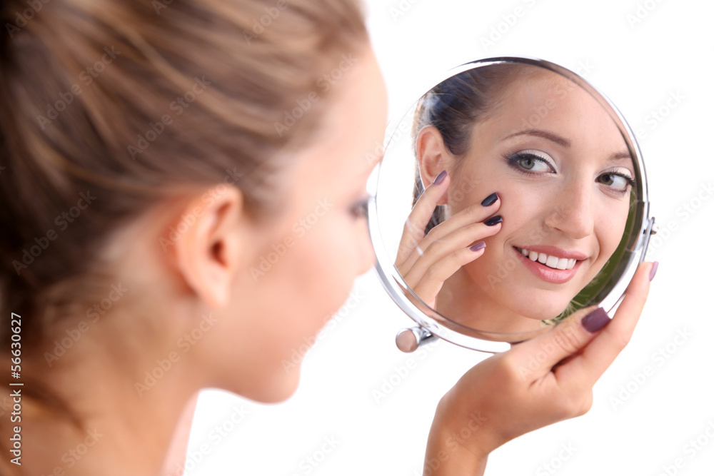 Beautiful girl preens before small mirror isolated on white Beautiful girl preens before small mirror isolated on white