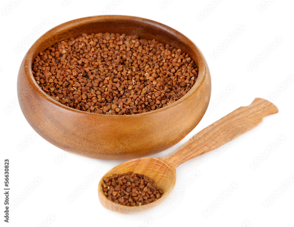 Buckwheat groats in bowl and wooden spoon isolated on white Buckwheat groats in bowl and wooden spoon isolated on white