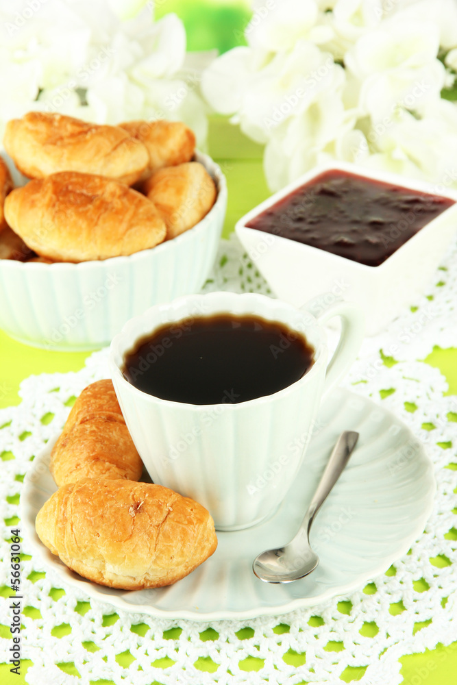 Tasty croissants and cup of coffee on table close-up Tasty croissants and cup of coffee on table close-up