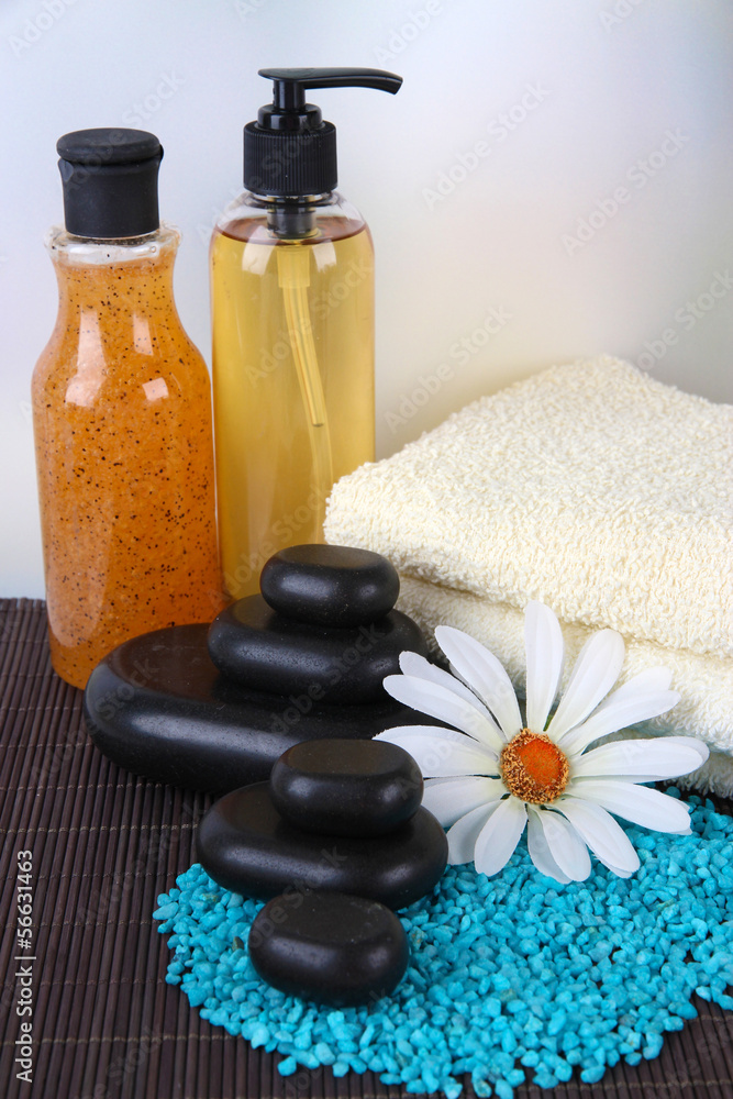 Beautiful spa setting on bamboo mat on bright background Beautiful spa setting on bamboo mat on bright background