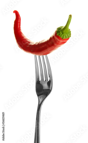 Red hot chili pepper on fork, isolated on white © Africa Studio