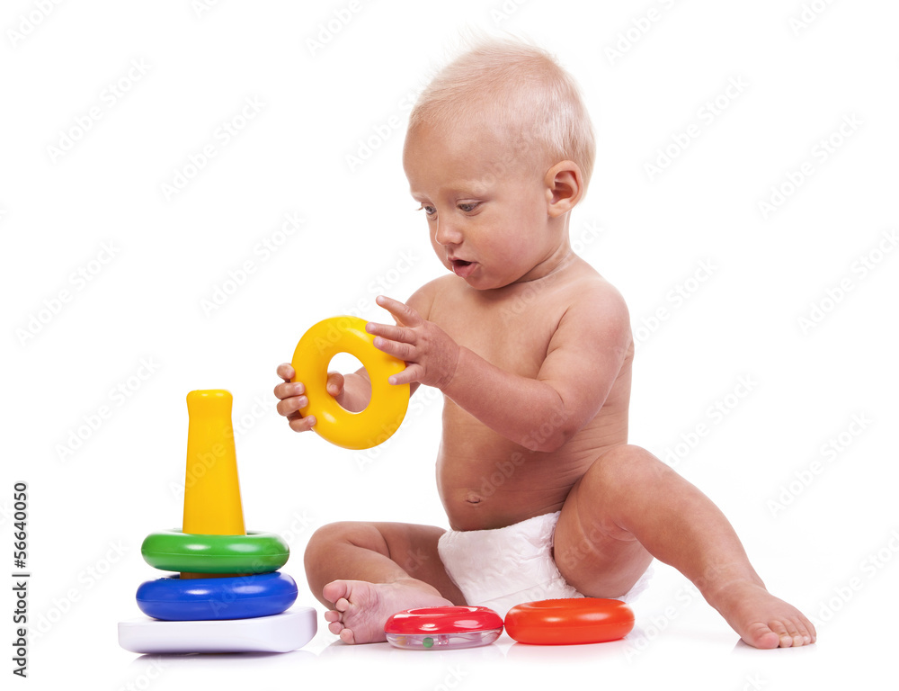 Cute little boy playing with pyramid toy over white Cute little boy playing with pyramid toy over white