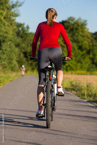 Healthy lifestyle - young woman biking
