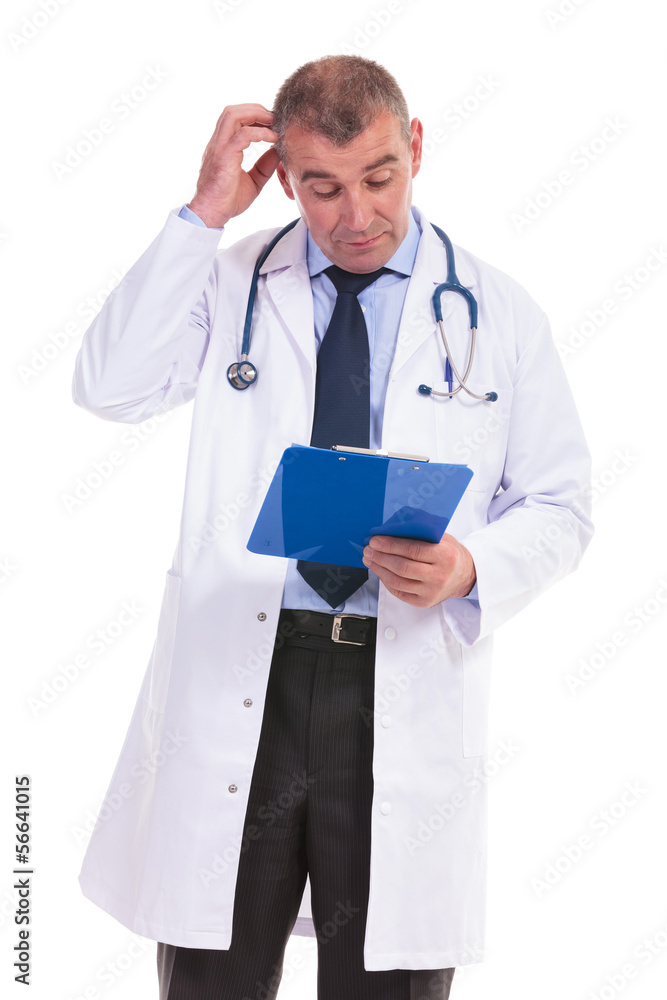 undeciced old doctor reading some results on his pad undeciced old doctor reading some results on his pad